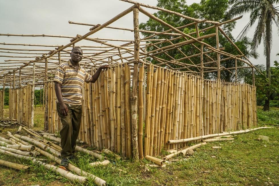 David Paye, a parent in Cinta, posing next to the makeshift annex the town is building to host kindergarten classes that were cut by Bridge.