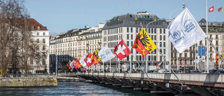 Flags marking the 2023 Global Refugee Forum are hung along the Pont du Mont Blanc in Geneva in December 2023. © UNHCR/Olivier Chamard